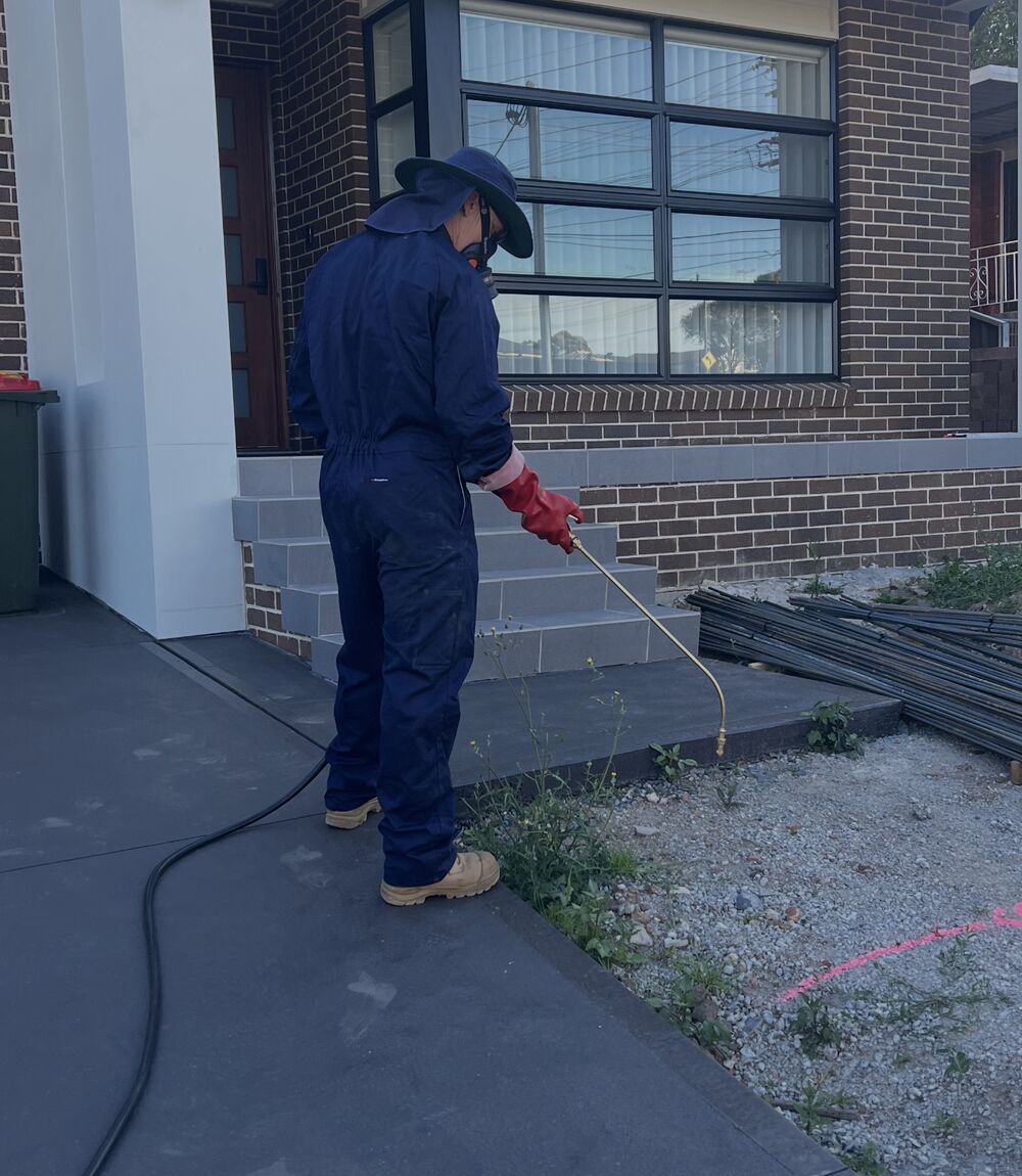 Doctor Pesty technician treating a garden bed and perimeter for general pests